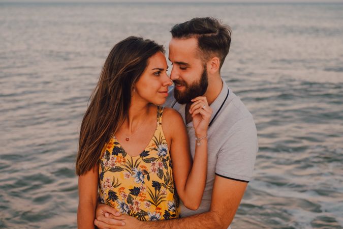 Loving couple embracing happily on sandy beach