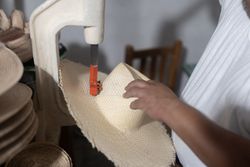 Making a hole in a natural fiber hat