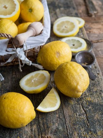 Lemons and reamer placed on wooden board