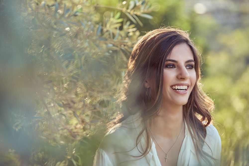 Delighted woman near green plants