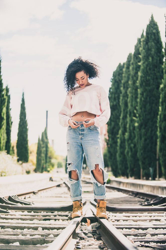 Beautiful Black woman on railroad
