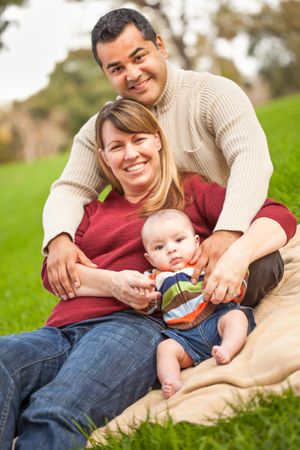 Happy Family Posing for A Portrait in the Park