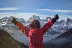 Anonymous kid celebrating success in mountains