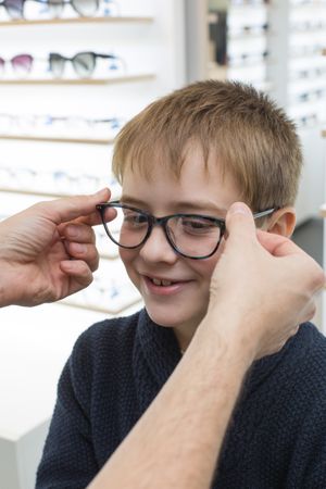 Young boy trying on glasses