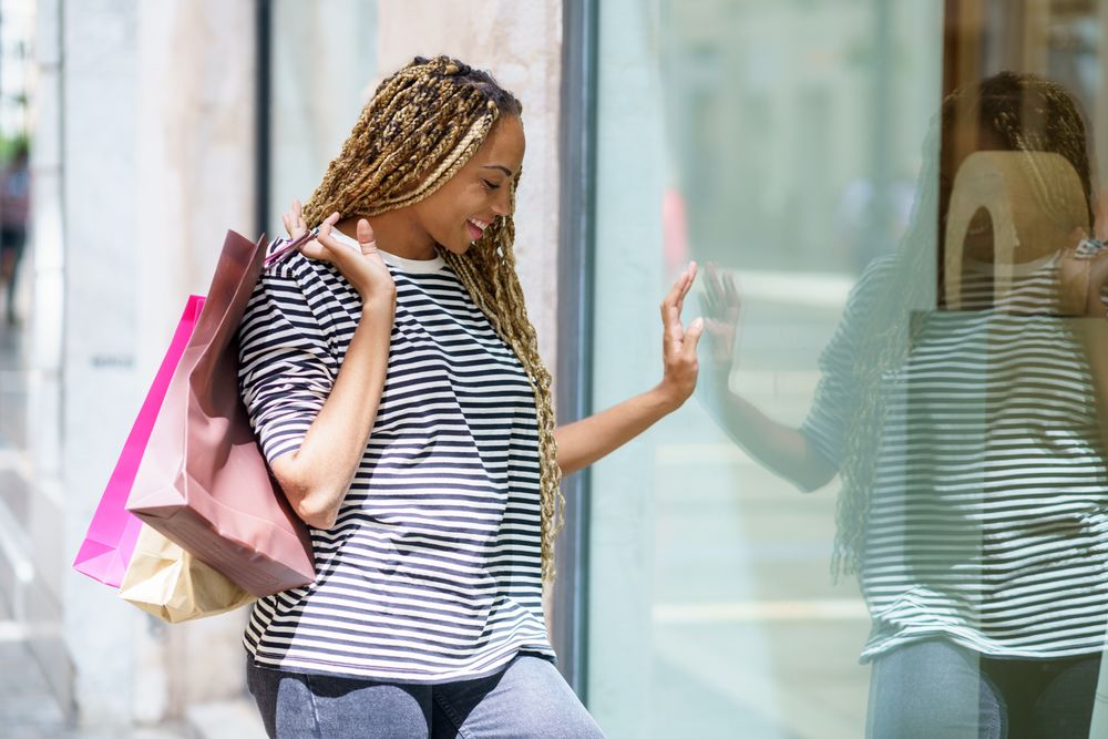 Female looking through window of shop