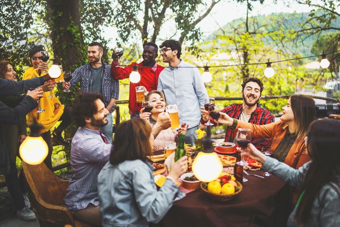 A quiet day with friends toasting together with wine and beer at sunset time