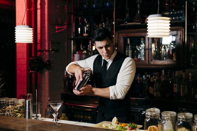 Barman working mixing drinks in a shaker