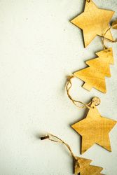 Close up of tree and star Christmas ornaments on marble counter