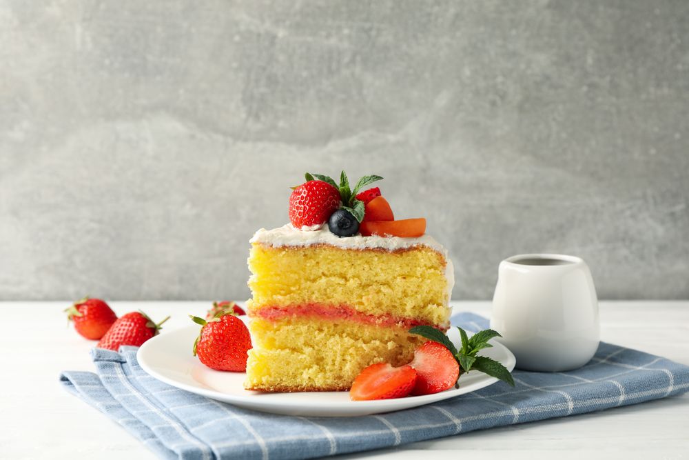 Composition with delicious berry cream cake against gray background. Tasty dessert