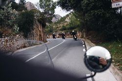 Motorcycle rider behind group of friends on bikes