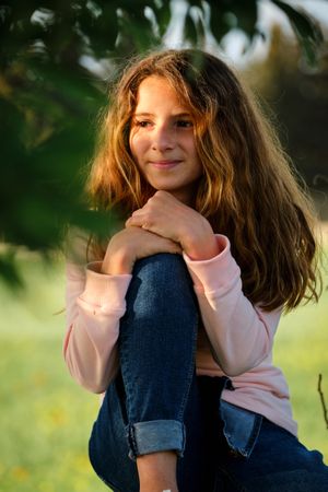Girl resting under tree in nature