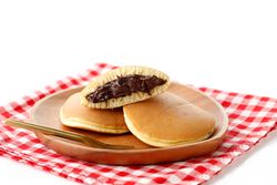 Fresh dorayaki pancakes filled with chocolate from Japan served on checkered napkin