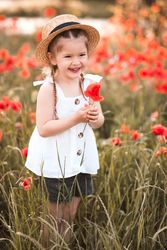 Happy girl standing in red meadow