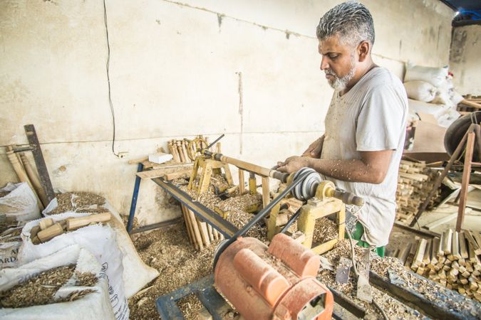 Man using woodworking machine at workplace