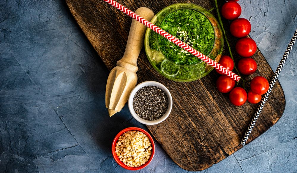 Green smoothie on concrete background with copy space