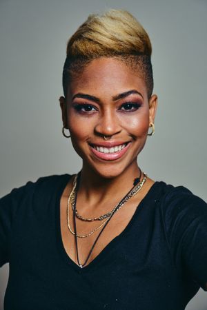 Portrait of smiling professional Black woman with short blonde hair