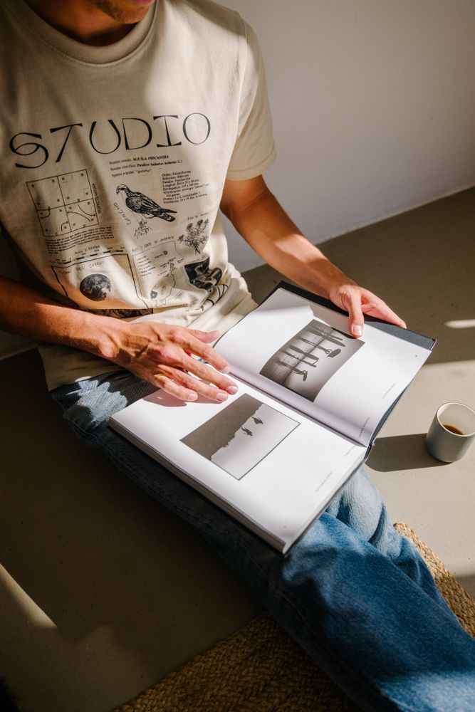 Person reading coffee table book in shop