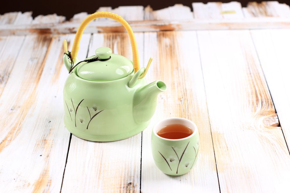 Green Chinese Asian Tepot with A Cup of Tea