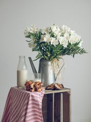Bouquet of flowers and food on wooden crate