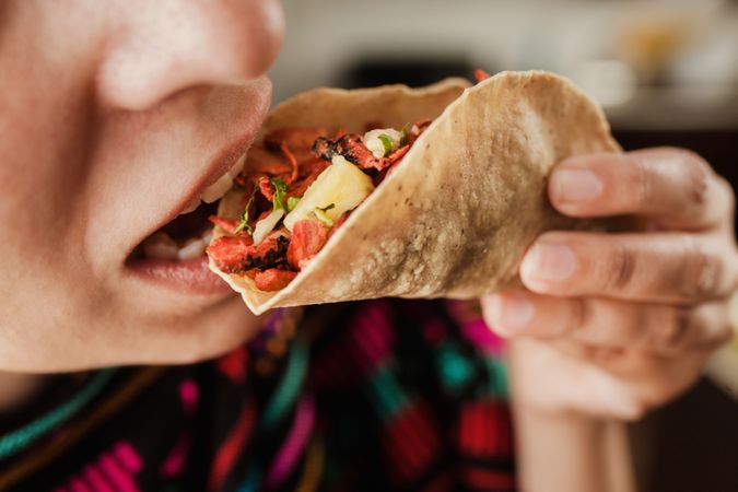 Crop woman with taco al pastor