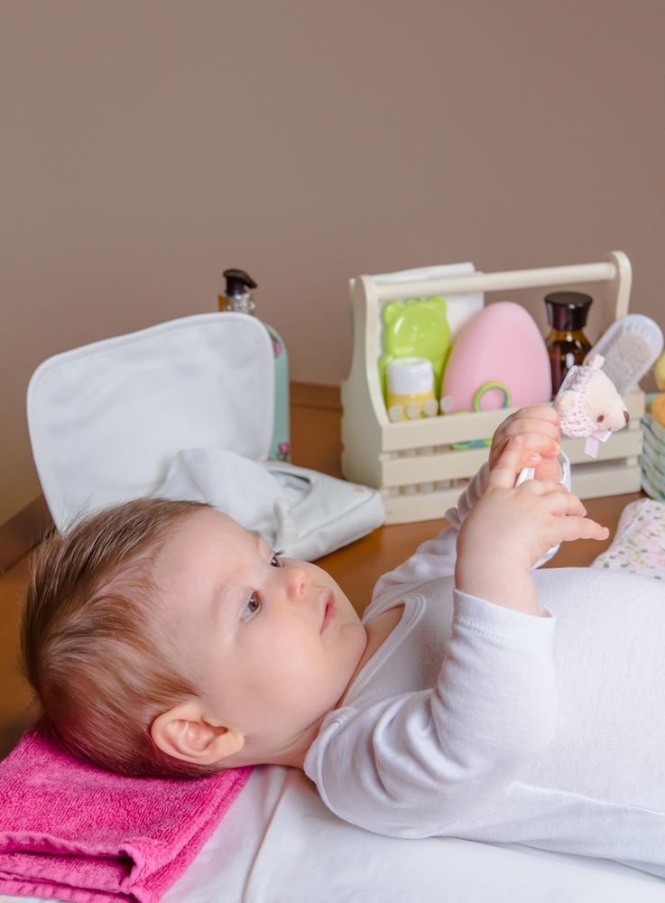 Cute baby playing with toy while lying down