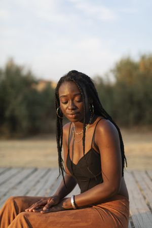 Portrait of a young Black female sitting and relaxing in the park