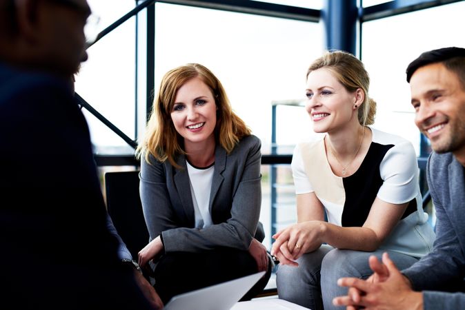 Male and female business associates having an informal meeting in an office