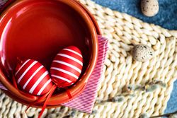 Easter holiday table setting with red egg decorations in red bowl