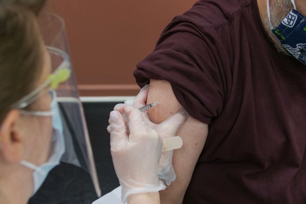 Healthcare worker injecting Covid-19 vaccine