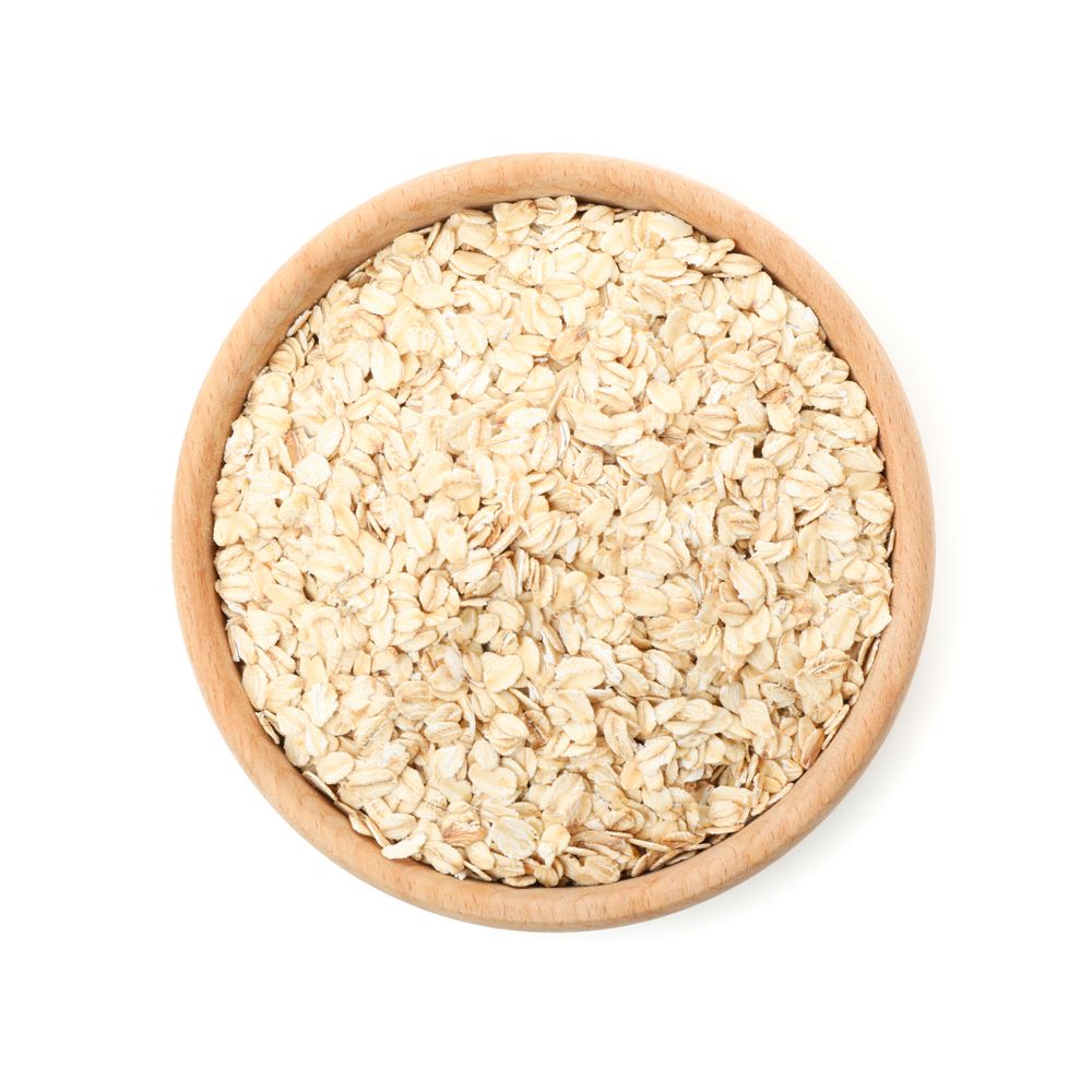 Bowl with oatmeal flakes isolated on plain background
