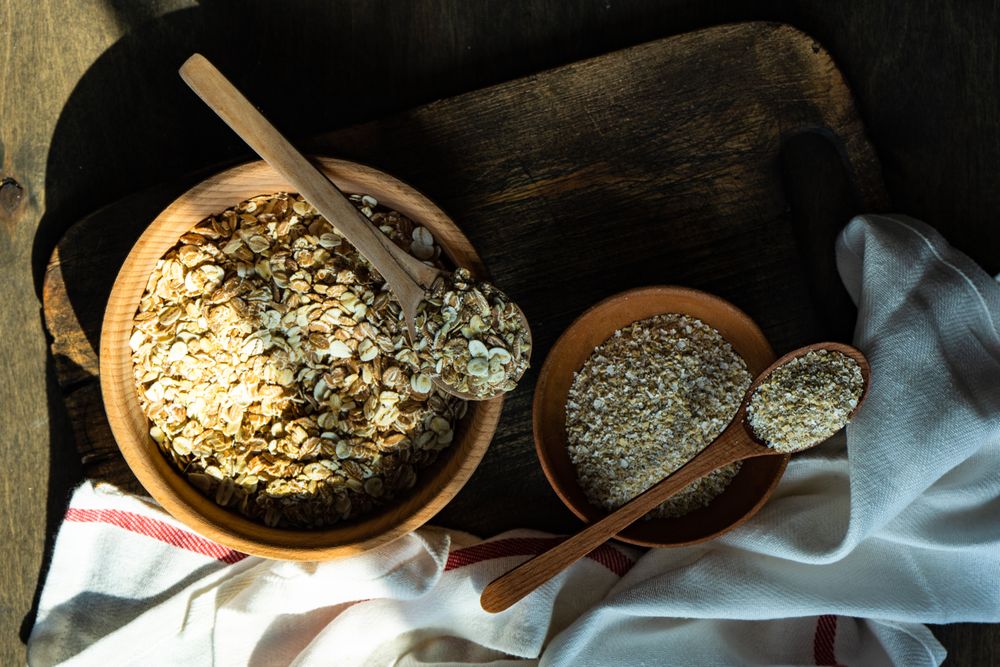 Top view of bowls of dry oats on kitchen counter