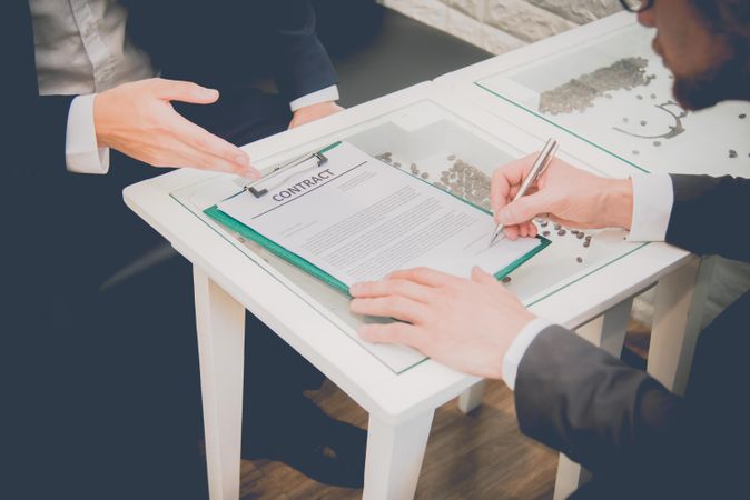 Man signing contract with business partner