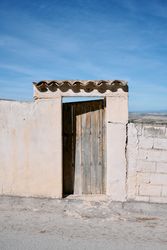 A deteriorated wooden door of a house in a small village in andalusia, Spain.