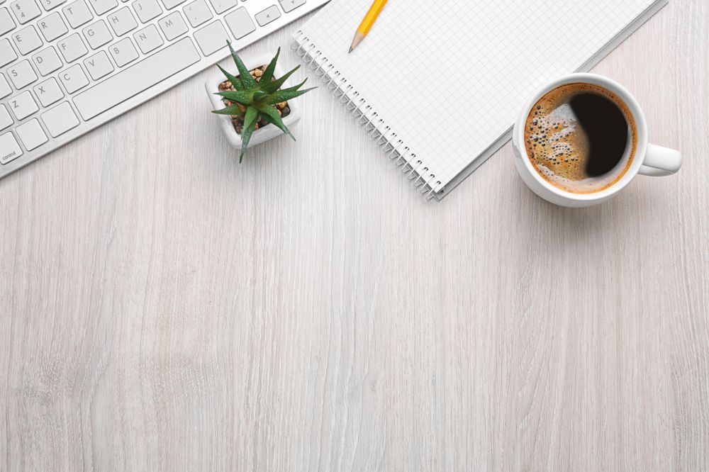 Cup of Coffee with Office Tools on Light Wooden Background