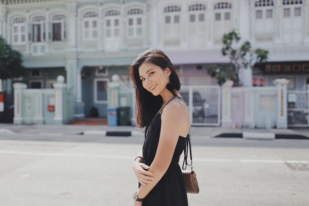 Side view of woman in dark dress posing outdoor