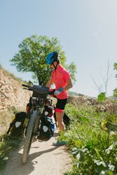 Woman riding bicycle in forest