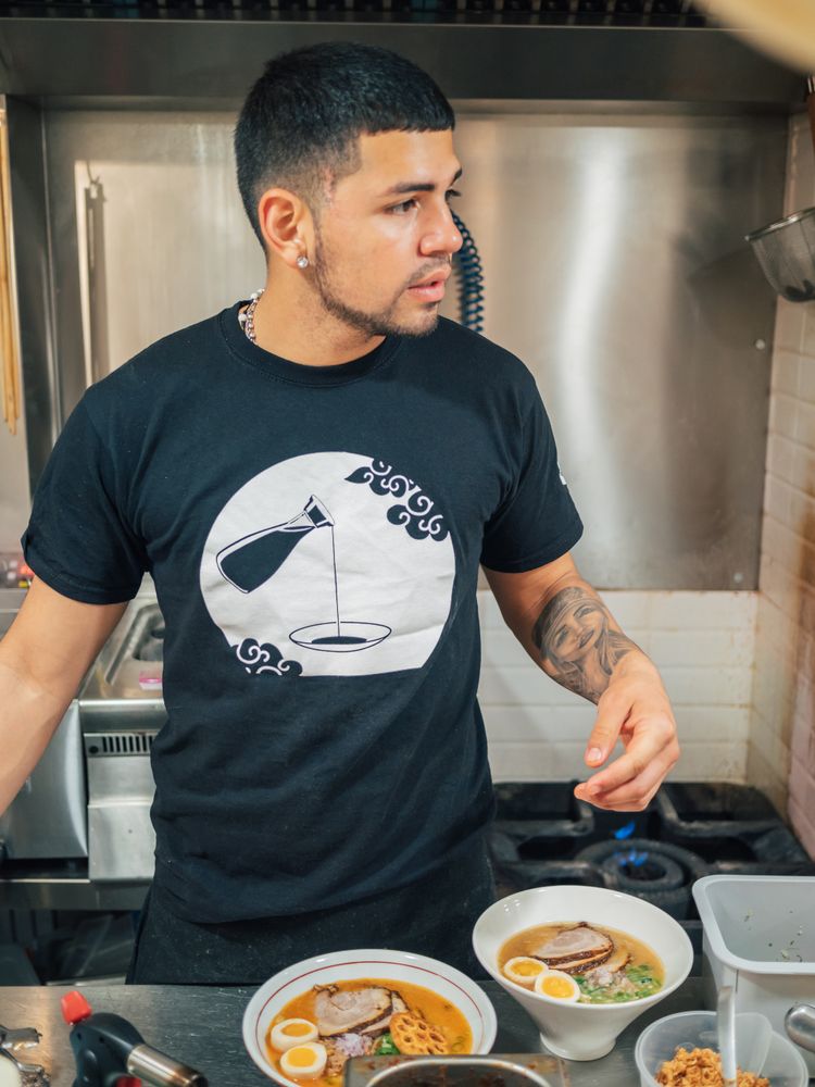 Asian chef with served bowls of ramen