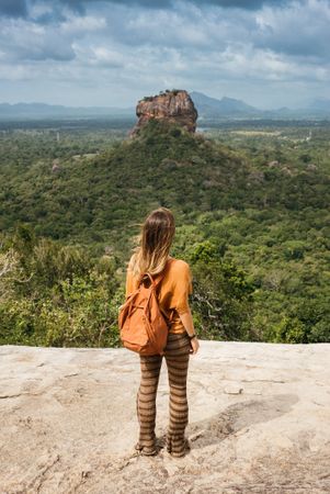 Back of woman taking in view over Sri Lankan forest