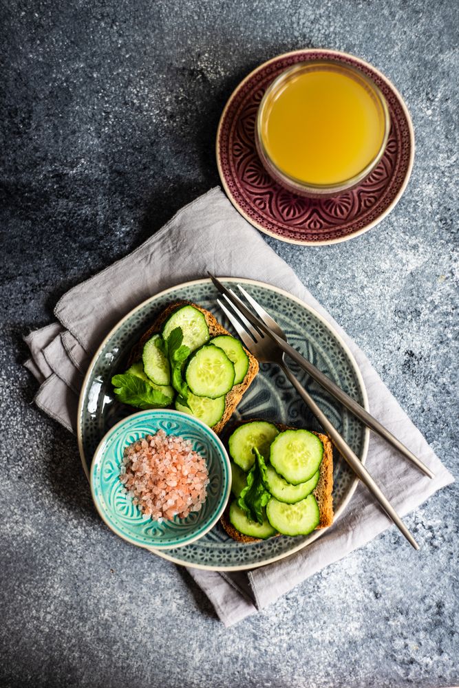 Top view of healthy lunch with vegetable cucumber toast and Himalayan salt