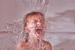Screaming child washing at home