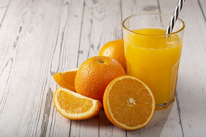 Glass with orange juice on the table.