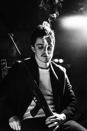 Man with cigarette and gun in hand