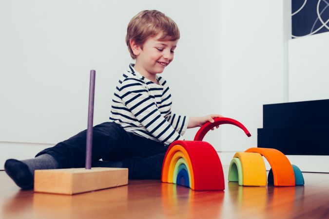 Boy playing with wooden construction pieces