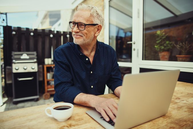 Man enjoying working outside  on this laptop