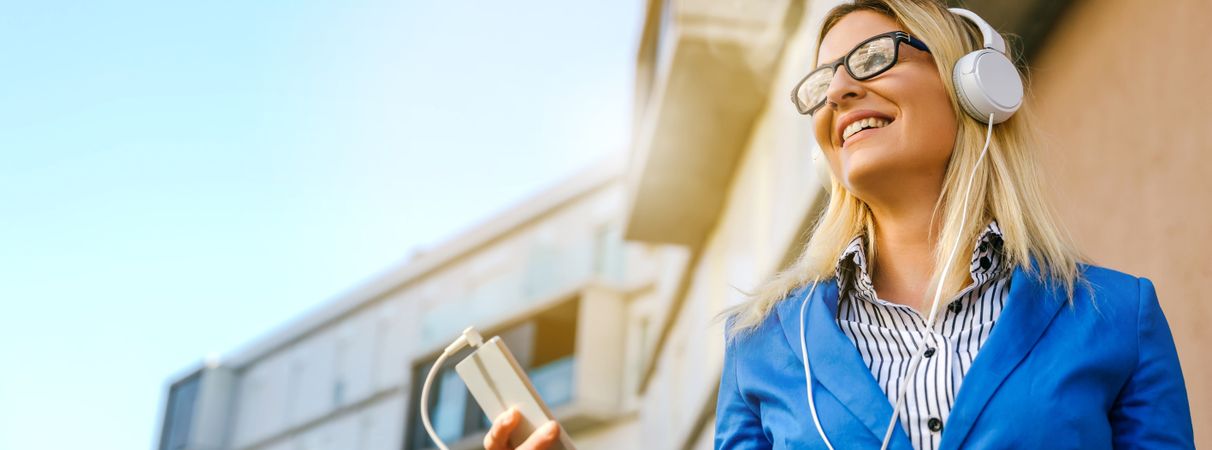 Businesswoman with headphones and mobile