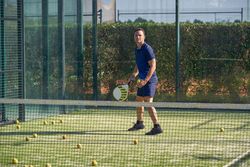 Sportsman playing padel on playground