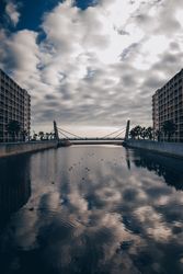 Watercanal between building and cloudy sky