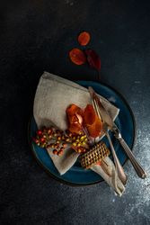 Top view of fall table setting with amber leaves