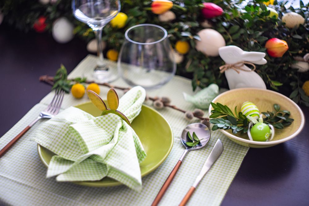 Easter table setting with rabbit napkin ring on pastel green napkin