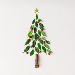 Christmas tree topped with star made of leaves, berries and branch